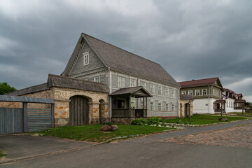 View of historical merchant buildings of estates on the main street of Izborsk Pechorskaya Street on a summer sunny day, Izborsk, Pskov region, Russia