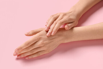 Fototapeta premium Beautiful female hands on pink background