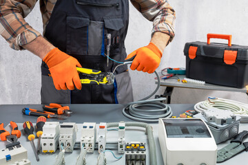  electrician working on an electrical panel with wires. electrician at work.
