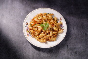 Mixed fried pasta is on tray. 