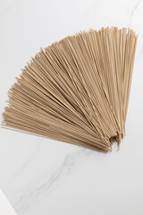 Uncooked soba noodles on marble table, flat lay
