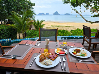 Savoring a delicious breakfast on Krabi, Thailand, where the tranquil beach and crystal-clear waters create an idyllic setting for a perfect morning retreat.