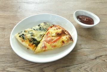 baking pizza topping spinach and seafood cocktail on plate dipping tomato sauce in cup