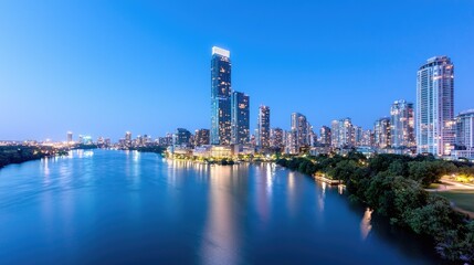 Fototapeta premium Cityscape twilight, river reflection, urban skyline, parkland