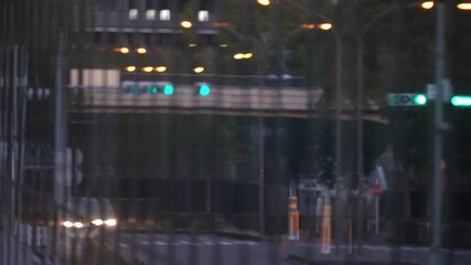 Tokyo,Japan - February 15, 2025: Reflection of a street on building wall and windows