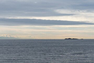 Fototapeta premium clouds over Strait of Georgia blue sky water landscape mountains on the horizon British Columbia Canada