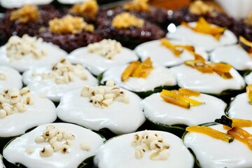 Khanom Tako (a Thai dessert made from glutinous rice flour and coconut cream, served in a pandan leaf or banana leaf casing) at Khlong Lat Mayom, a floating market in Taling Chan, Bangkok, Thailand