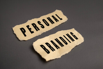 personal branding words text on torn paper on gray background