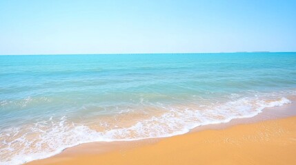 Obraz premium Tranquil beach scene, calm waves, golden sand, hazy horizon
