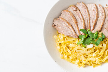 dried duck noodles in white bowl