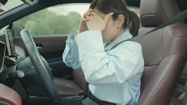 woman feeling stress and angry during drive car long time. Asian girl tired and fatigue having headache after driving car in traffic jam. Sleepy, stretching and drunk concept