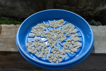 Leftover rice is dried in the sun on a bamboo tray, in Indonesia it is called nasi aking. Usually used to feed chickens and ducks, Aking rice is made from leftover