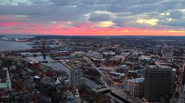 Providence, Rhode Island drone video at dusk. Aerial 4K footage of Providence River in South Providence city district backed by a pink sky