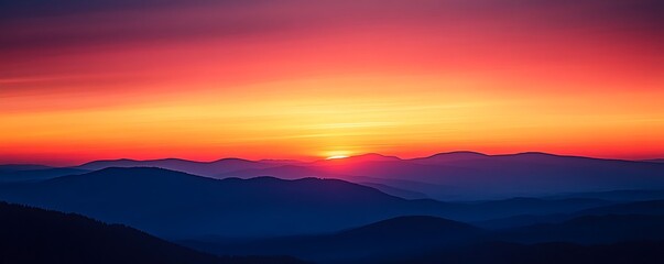 Obraz premium A breathtaking sunset over rolling mountains, showcasing vibrant hues of orange, pink, and purple. The serene view offers a perfect escape into nature's beauty and tranquility.