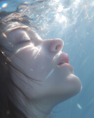 Ethereal underwater portrait of a serene woman with sunlight reflections and gentle water movements