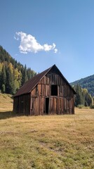 Obraz premium Rustic Wooden Barn in a Beautiful Mountain Landscape