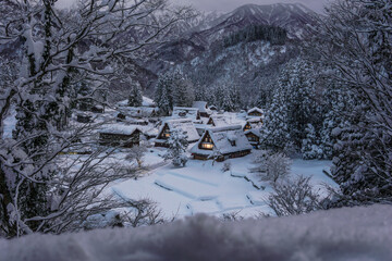 Ainokura Village glows under the winter night, with traditional Gassho-zukuri houses covered in snow.