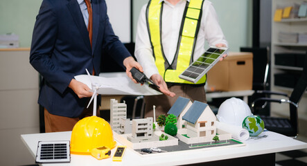 Architects and designers collaborate on urban plans, models and green solutions. A modern office setting focused