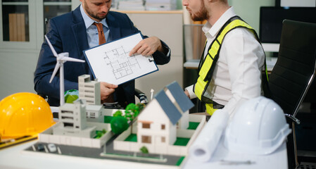 Architects and designers collaborate on urban plans, models and green solutions. A modern office setting focused