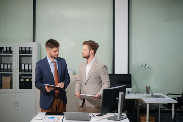 Caucasian business team collaborates on a new startup project, planning strategies with a tablet and laptop