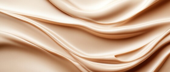 Obraz premium Smooth beige satin fabric with gentle waves and folds