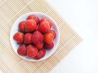 Strawberries in a small white plate. Top of view. 