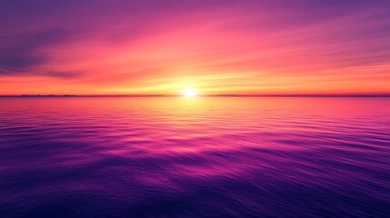 Obraz premium A breathtaking sunset over calm ocean waters, featuring vibrant shades of purple, pink, and orange. The horizon glows as the sun sinks, creating a serene and picturesque scene.