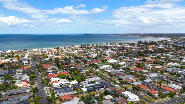Aerial view of Seaholme, a bayside suburb of Melbourne, Australia, overlooking Altona Beach, suburban residential streets, and the coastline of Port Phillip Bay in the western suburbs.