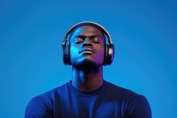 Calm expression captures connection to music in vibrant blue bac