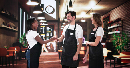 Multiracial team celebrates successful new chef