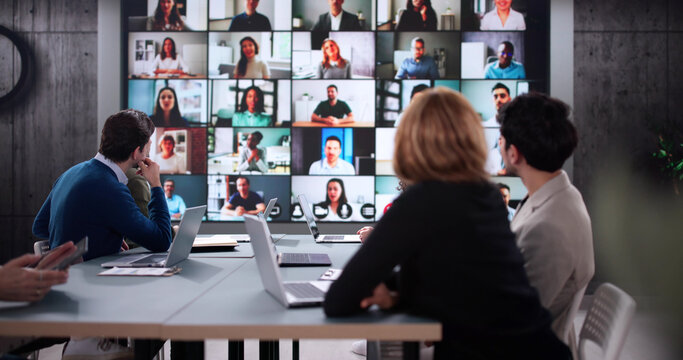 Tech-savvy executive leading corporate meeting via online video