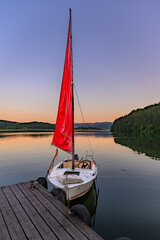 The red boat at sunset at the lake