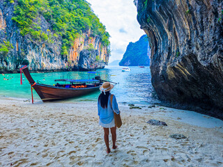 Explore the serene beauty of Koh Hong Island in Thailand surrounded by lush cliffs and clear waters