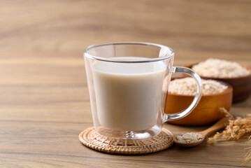 Oat milk in cup glass on wooden background, Alternative milk made from plant, non dairy