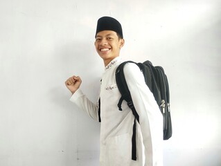 Asian Muslim man holding a black bag 
