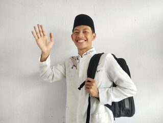 Asian Muslim man holding a black bag 
