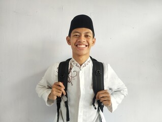Asian Muslim man holding a black bag 