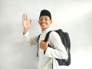 Asian Muslim man holding a black bag 