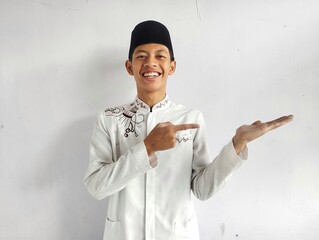A muslim man smiling happy with one hand holding invisible object