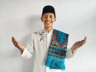 Moslem Asian man smiling at the camera with arms open doing welcoming gesture