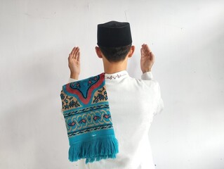 Back view of moslem man doing praying gesture