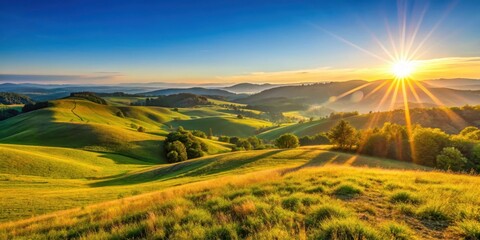 Fototapeta premium Warm golden light rays illuminating a serene landscape with gentle hills and a clear blue sky at sunset, landscape