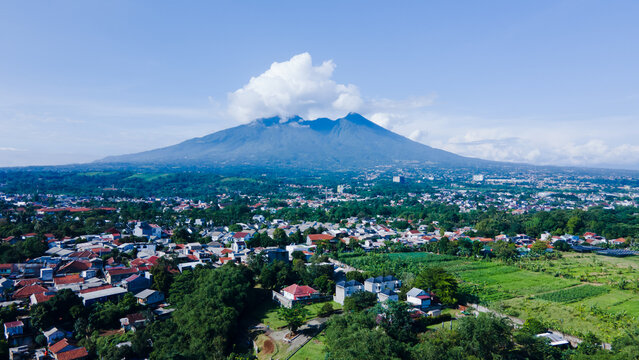 Densely Populated Housing with a Mountain Covered in Clouds - Powered by Adobe