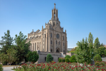 Red roses at the ancient Catholic cathedral of the Sacred Heart of Jesus. Tashkent, Uzbekistan