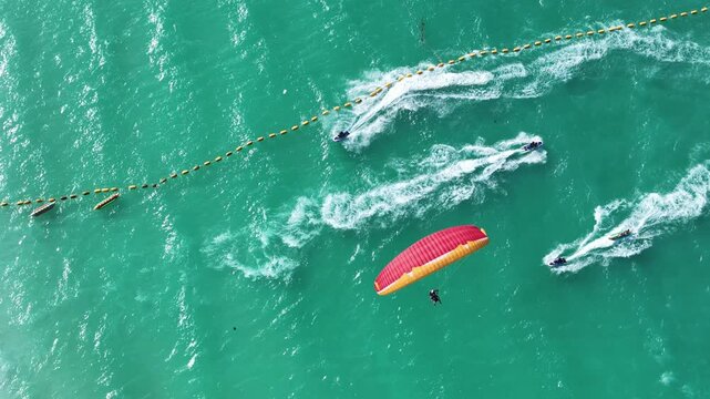 Paragliding in Thailand with blue sea. Two man paragliding high up in the sky. tourist attraction. Paraglider flies above the mountains in a bright sunny day