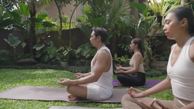 Meditation Yoga Pose Movement On Beautiful Lush Garden Green Grass in Ubud Bali Indonesia
