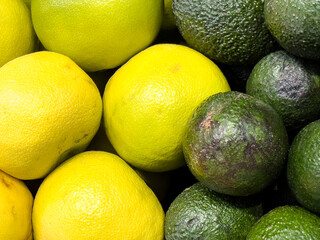 Fresh lemons and avocados in a vibrant arrangement at a local market showcase seasonal produce