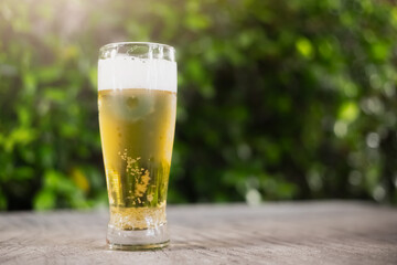 Beer glass on wooden board . Blurred background party party. Cold beer.

