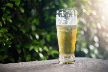 Beer glass on wooden board . Blurred background party party. Cold beer.
