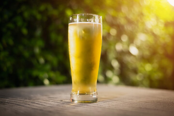 Beer glass on wooden board . Blurred background party party. Cold beer.
